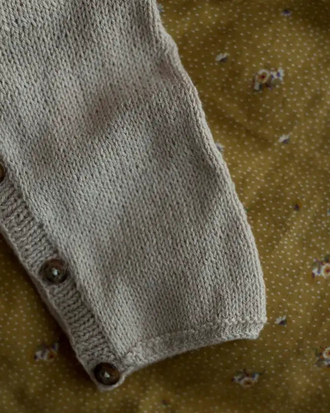 Produktfoto: Emma’s Suit, Strickanleitung für einen Babystrampler in Raglan von oben